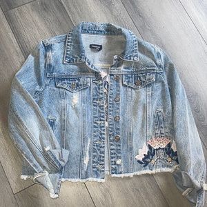 Beautiful Bebe jean jacket with embroidered detail.
